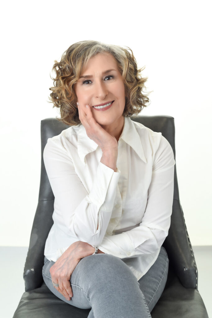 Confident mature woman smiling naturally during a professional photography session