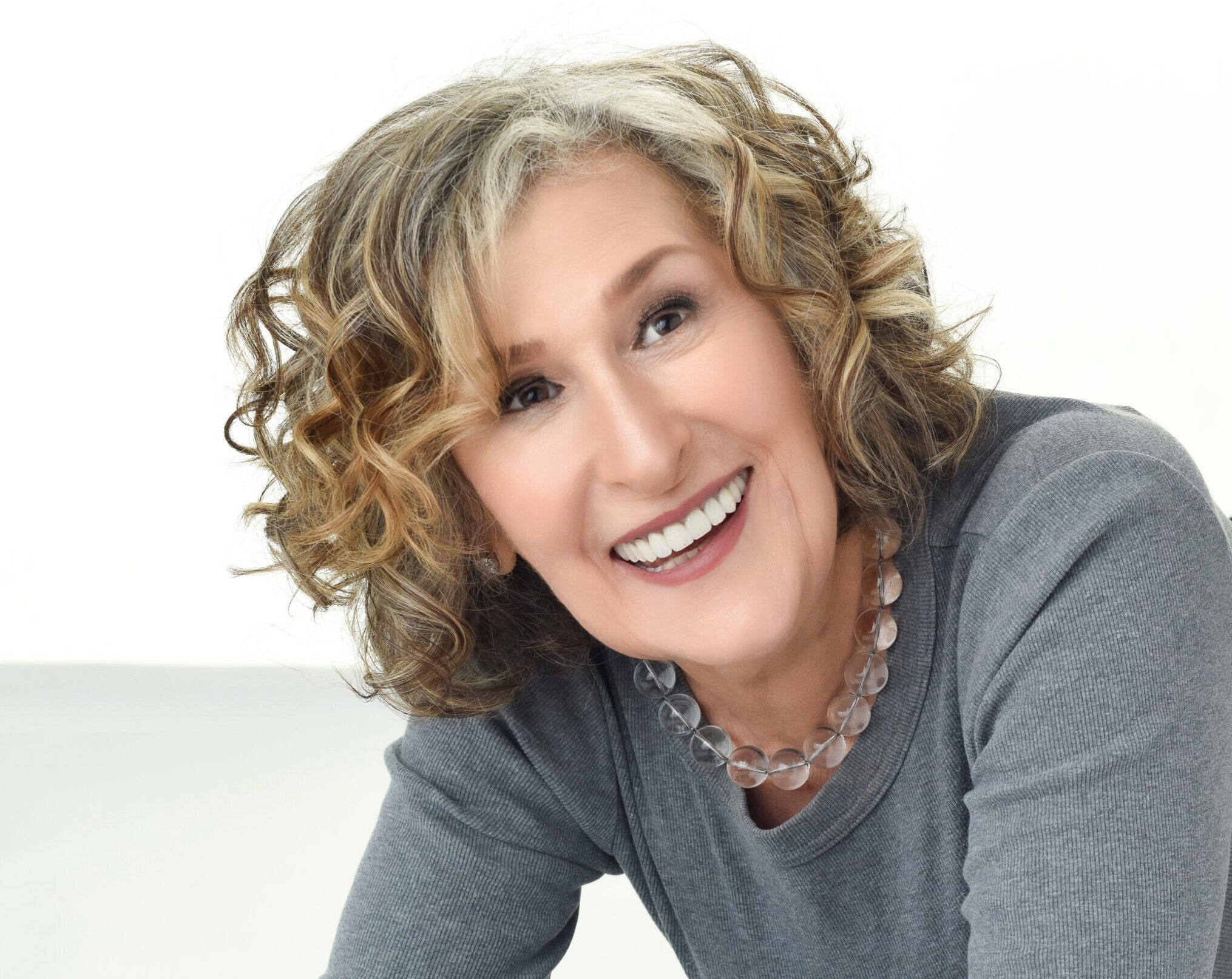 Woman over 40 looking confidently at the camera during a professional portrait session