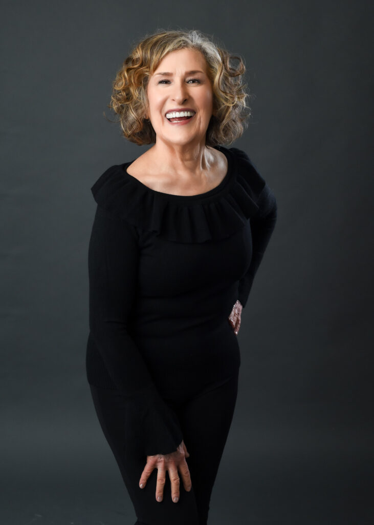 Mature woman posing naturally for a professional portrait with soft studio lighting